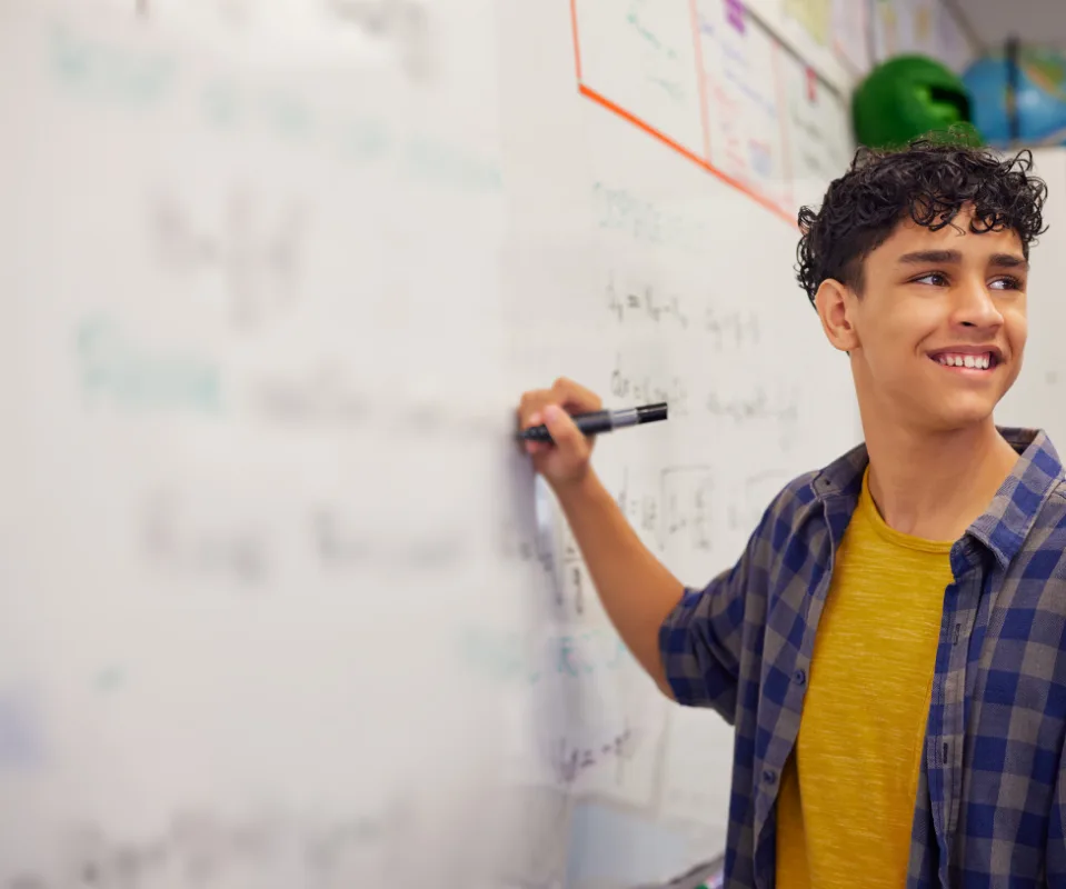 student writing on a whiteboard