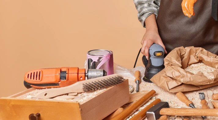 Image of female carpenter doing work on a wood surface